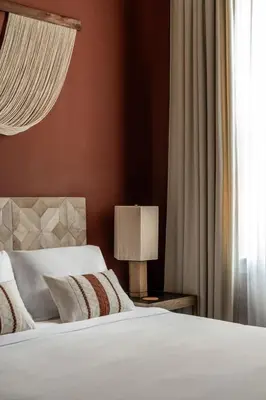 a bedroom with a bed with a lamp and a window at Luxurious Artisan Loft w Chic Design - The Tanner in Philadelphia