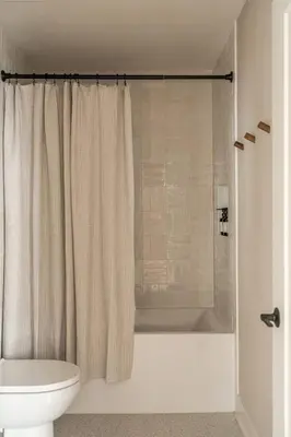 a bathroom with a shower curtain and a toilet at Luxurious Artisan Loft w Chic Design - The Tanner in Philadelphia