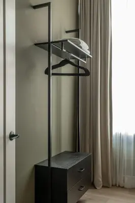 a black shelf in a room next to a window at Luxurious Artisan Loft w Chic Design - The Tanner in Philadelphia
