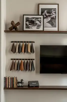 a living room with a tv and a shelf with coffee cups at Luxurious Artisan Loft w Chic Design - The Tanner in Philadelphia