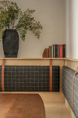 a room with a couch and a shelf with books at Luxurious Artisan Loft w Chic Design - The Tanner in Philadelphia