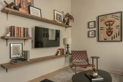 a living room with a chair and a mirror at Exquisite Artisan Loft w Chic Design - The Cobbler in Philadelphia