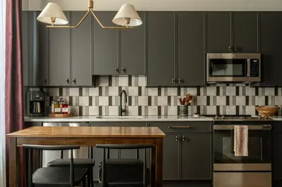 a kitchen with gray cabinets and a wooden counter top at Exquisite Artisan Loft w Chic Design - The Cobbler in Philadelphia