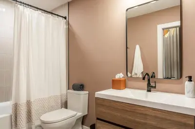 a bathroom with a toilet and a sink and a mirror at Chic Artisan Loft w Stylish Design - The Sculptor in Philadelphia