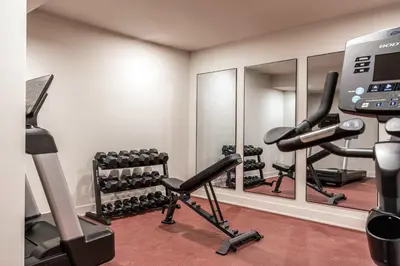 a fitness room with tread machines and mirrors at Chic Artisan Loft w Stylish Design - The Sculptor in Philadelphia