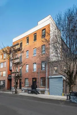 a large brick building on the side of a street at Chic Artisan Loft w Stylish Design - The Sculptor in Philadelphia