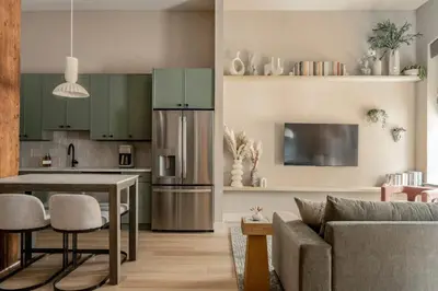 a kitchen and living room with a couch and a table at Chic Artisan Loft w Stylish Design - The Sculptor in Philadelphia