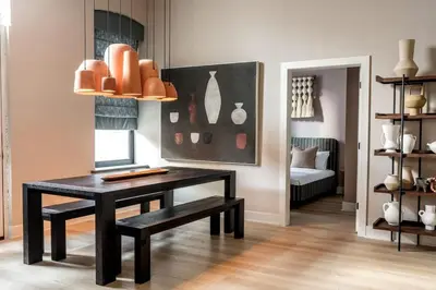a room with a table and a bench and a room with a bed at Stylish Artisan Loft w Chic Design - The Potter in Philadelphia