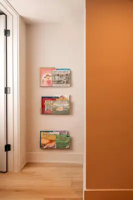 a corner of a room with three books on a wall at The Artisan's Townhome - 4Bed Roofdeck - The King in Philadelphia