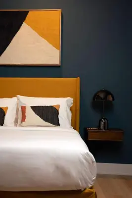 a bedroom with a white bed with a blue wall at The Artisan's Townhome - 4Bed Roofdeck - The King in Philadelphia