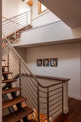 a staircase in a house with three pictures on the wall at The Artisan's Townhome - 4Bed Roofdeck - The King in Philadelphia