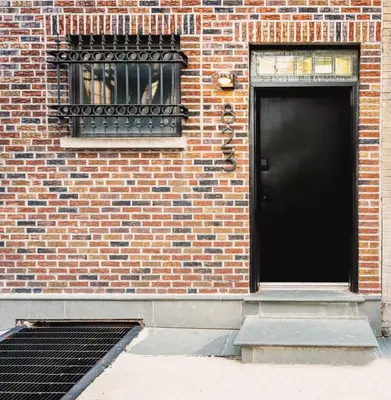 a brick building with a black door and a window at The Artisan's Townhome - 4Bed Roofdeck - The King in Philadelphia
