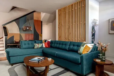 a living room with a blue couch and a table at The Artisan's Townhome - 4Bed Roofdeck - The King in Philadelphia