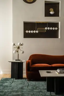 a living room with a brown couch and a table at The Artisan's Duplex - 8Bed -5Bath with 2 Car Parking in Philadelphia