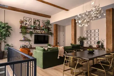 a living room with a green couch and a table at The Artisan's Duplex - 8Bed -5Bath with 2 Car Parking in Philadelphia