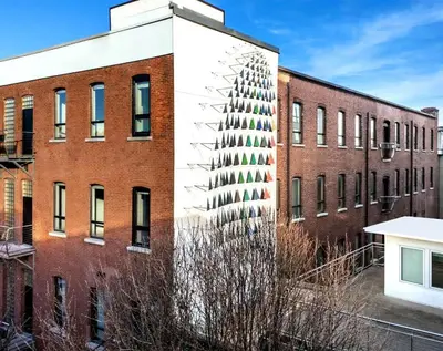 an exterior view of a brick building at The Artisan's Duplex - 8Bed -5Bath with 2 Car Parking in Philadelphia