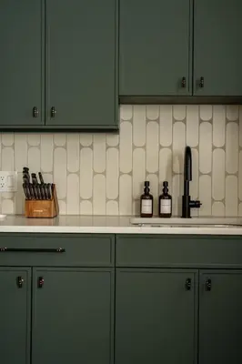 a kitchen with green cabinets and a counter top at The Artisan's Duplex - 8Bed -5Bath with 2 Car Parking in Philadelphia