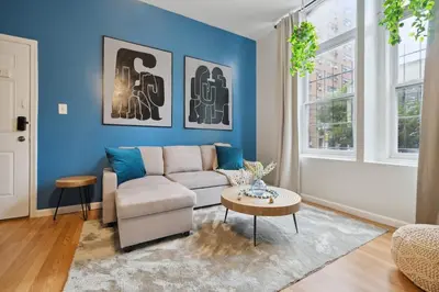a living room with a couch and a table at Big & Bright 1BR - Center City - Walk Everywhere! in Philadelphia