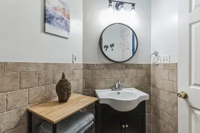 a bathroom with a sink and a mirror at Big & Bright 1BR - Center City - Walk Everywhere! in Philadelphia