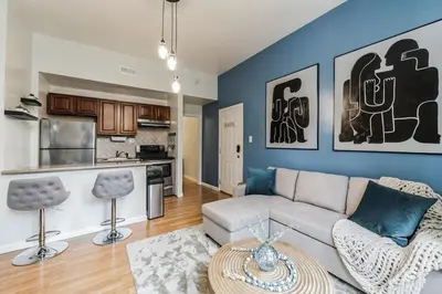 a living room with a couch and a table at Big & Bright 1BR - Center City - Walk Everywhere! in Philadelphia