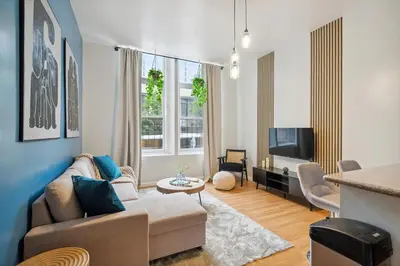 a living room with a couch and a tv at Big & Bright 1BR - Center City - Walk Everywhere! in Philadelphia