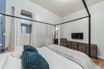 a bedroom with a large bed and a television at Big & Bright 1BR - Center City - Walk Everywhere! in Philadelphia