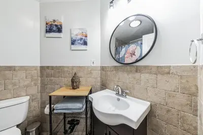 a bathroom with a sink and a mirror at Big & Bright 1BR - Center City - Walk Everywhere! in Philadelphia