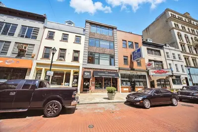 a black truck parked on a city street with buildings at Center City - Modern 2 Bedroom in Philadelphia