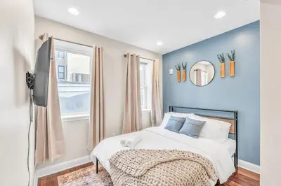 a bedroom with a bed and a window at Modern 2 bedroom - Center City in Philadelphia