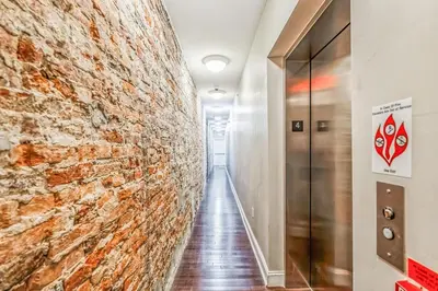 a hallway with a brick wall and a elevator at Modern 2 bedroom - Center City in Philadelphia