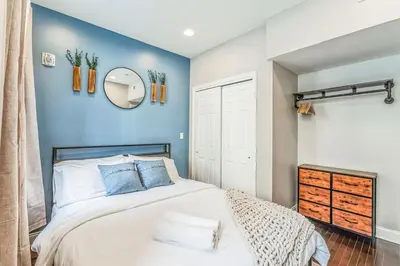 a bedroom with a bed and a blue wall at Modern 2 bedroom - Center City in Philadelphia