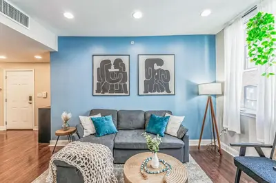 a living room with a couch and a blue wall at Modern 2 bedroom - Center City in Philadelphia