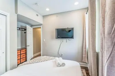 a bedroom with a bed and a tv on the wall at Modern 2 bedroom - Center City in Philadelphia