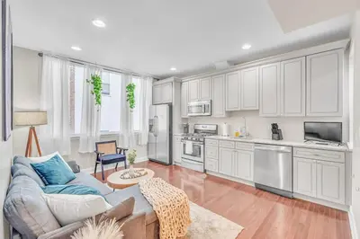 a living room with a couch and a kitchen at Modern 2 bedroom - Center City in Philadelphia