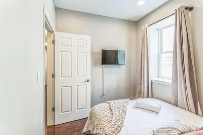 a bedroom with a bed and a window and a door at Modern 2 bedroom - Center City in Philadelphia
