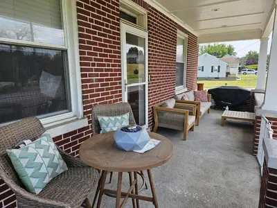 a patio with chairs and a table on a house at Old Charm Getaway in New Cumberland