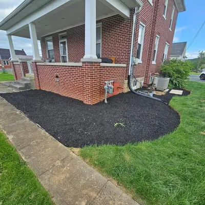 a yard in front of a brick house at Old Charm Getaway in New Cumberland