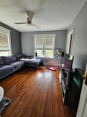 a living room with a couch and a television at Old Charm Getaway in New Cumberland