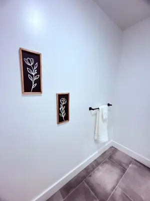 a room with two pictures on the wall and a tile floor at Luxury Stay in Newark