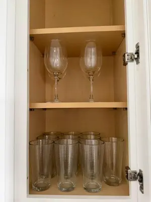 a cupboard with wine glasses in it at Chic & Comfy Apartment