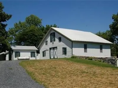 a white barn with a gambrel roof at Stocks Manor Bed and Breakfast in Mechanicsburg