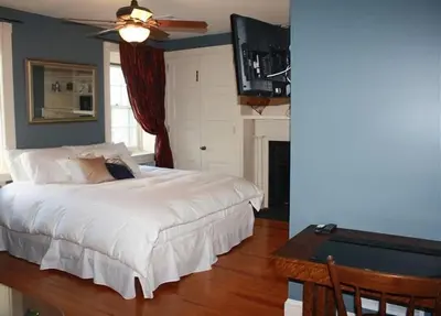 a bedroom with a white bed and a pool table at Stocks Manor Bed and Breakfast in Mechanicsburg