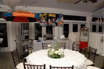 a dining room with a table and an umbrella at Stocks Manor Bed and Breakfast in Mechanicsburg