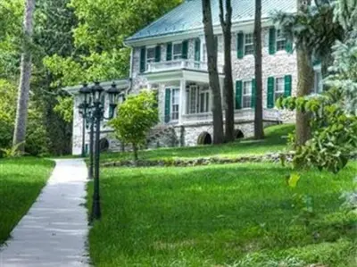 a large stone house with a pathway in front of it at Stocks Manor Bed and Breakfast in Mechanicsburg