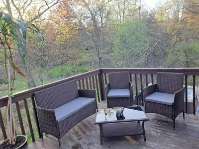 three chairs and a table on a deck with a view at Charming Family Friendly House, Hot tub, Playroom in Long Pond
