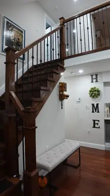a wooden staircase with a bench in a room at Secluded Forest Escape with Game Room, Hot Tub and Fire Pit in Thornhurst