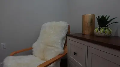a white furry chair sitting next to a counter at Secluded Forest Escape with Game Room, Hot Tub and Fire Pit in Thornhurst