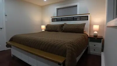 a bedroom with a bed with two lamps and a window at Secluded Forest Escape with Game Room, Hot Tub and Fire Pit in Thornhurst