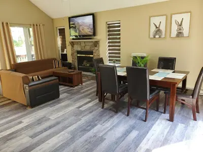 a living room with a dining table and a couch at GreatEscape Nature Playground HiSpeedInternet in Long Pond