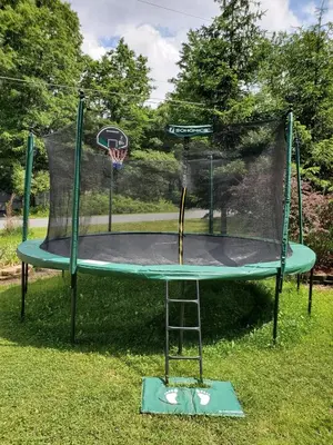 a basketball hoop with a net on the grass at GreatEscape Nature Playground HiSpeedInternet in Long Pond